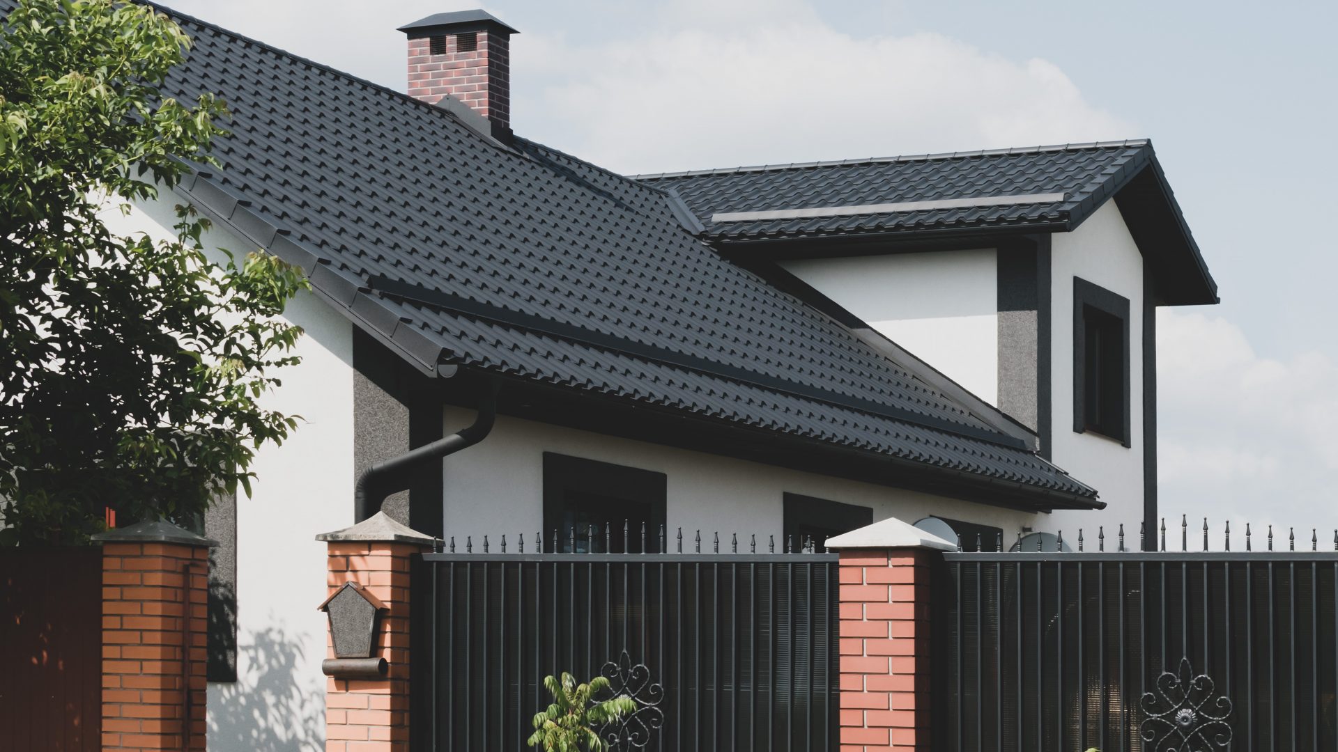 The dark-colored roof of a new residential private house