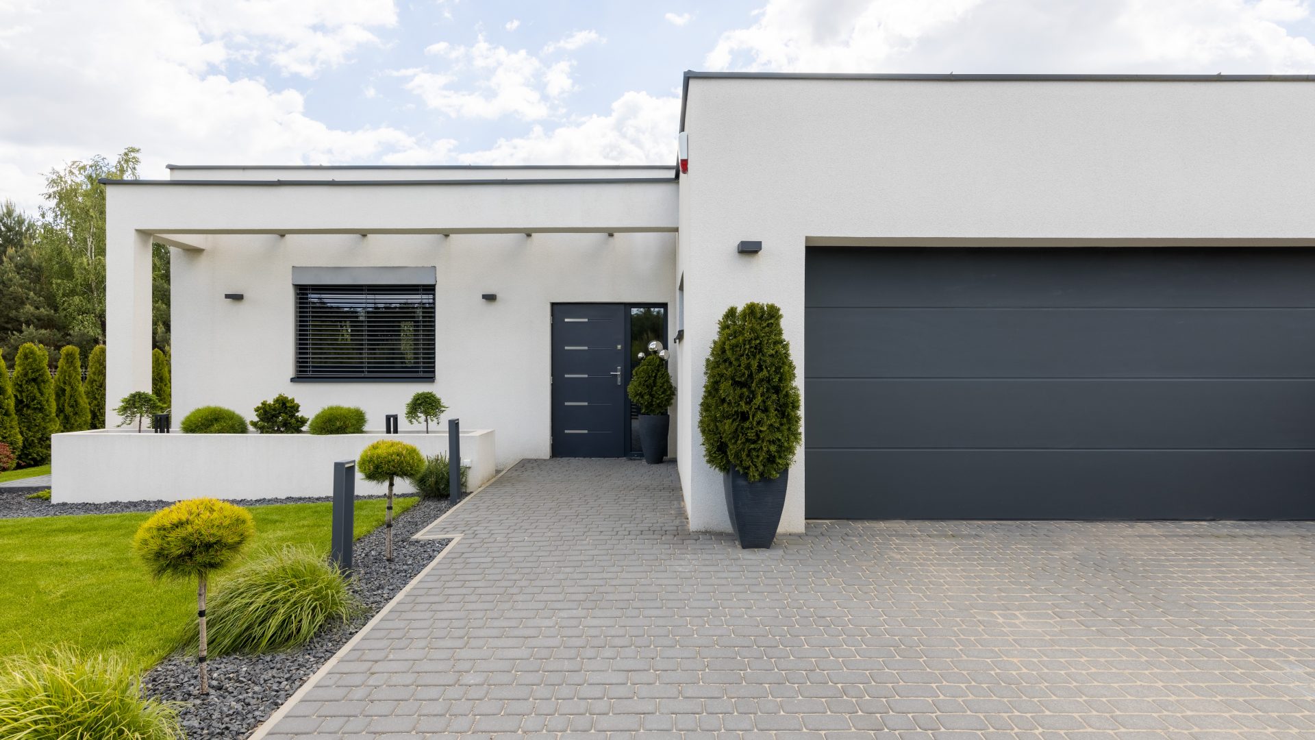 Outside view of elegant suburban house with big window green lawn